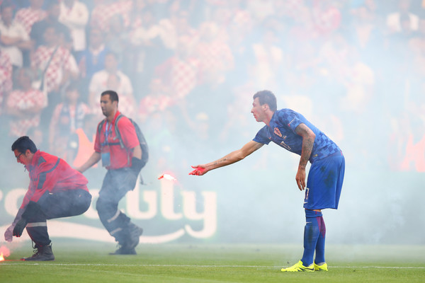 Mandzukic reacts as flares are thrown onto the picth in Croatia-Czech Game